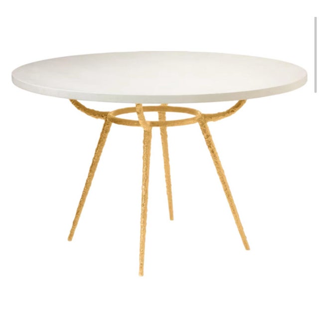 Stunning made goods dining table. Features a stunning pitted bottom metal bottom in gold. Beautiful linen with faux...