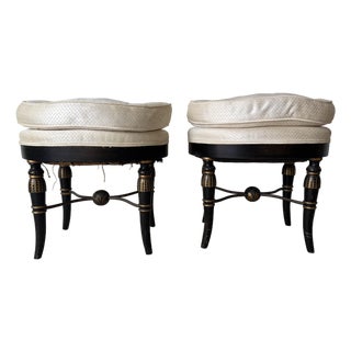 Pair of Vintage Hollywood Regency Black & Gold Ebonized Ottomans With Brass “X” Stretcher Base and Tufted Cushions For Sale