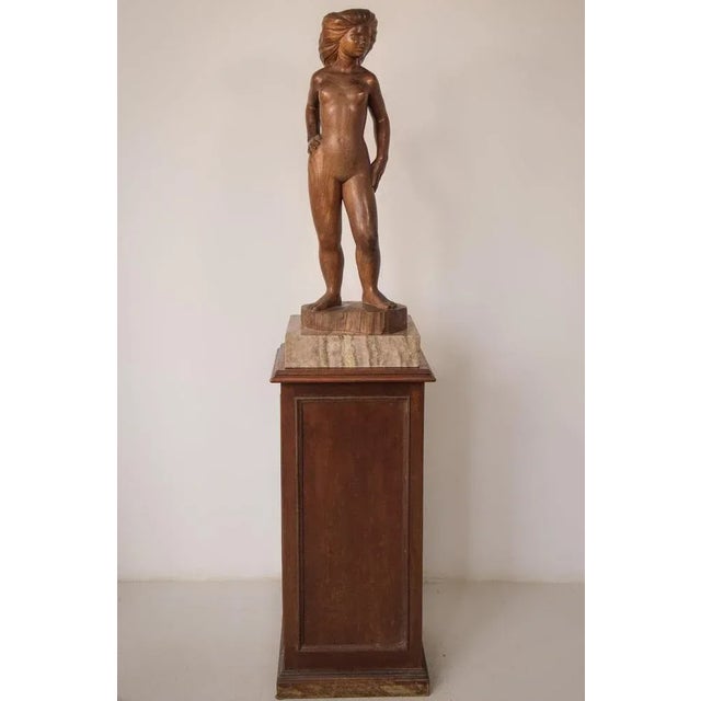With a strong stance and hair in the style of a lion's mane, this powerful figure is exceptionally carved from wood, with...