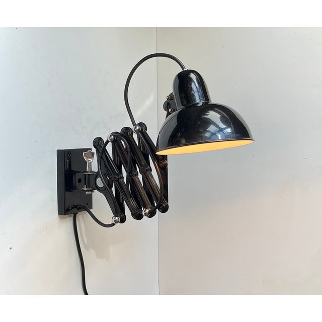 Very similar to Christian Dell's 6718 for Kaiser Idell comes this stylish industrial articulated scissor wall light. It is...