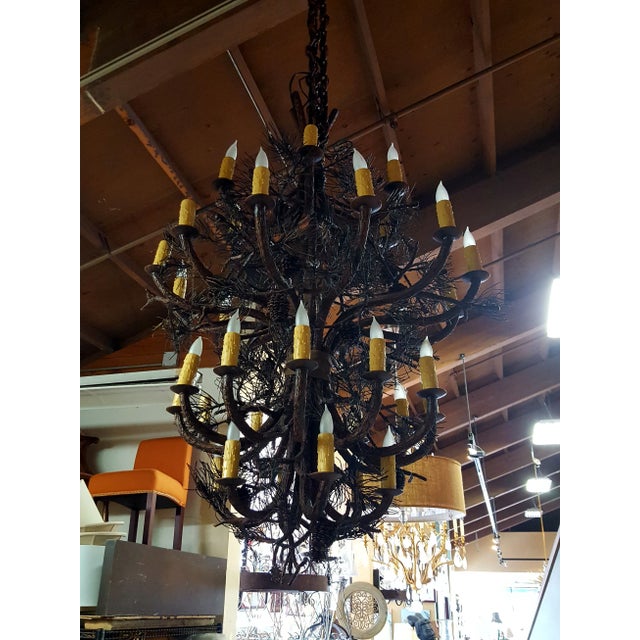This is a very large four-tier Mountain Pine Tree and Pine Cone sculpture chandelier by Berry Bates. The piece shows four...