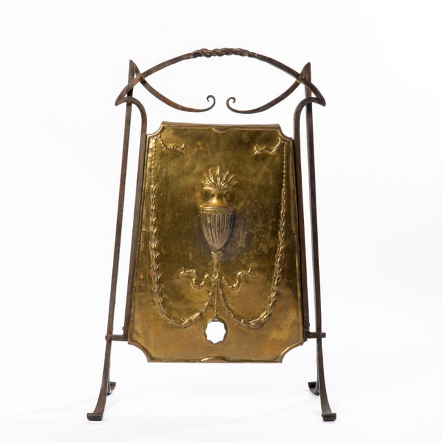 This decorative copper and wrought iron fire screen brings a stylish and unique touch to your living room or den.