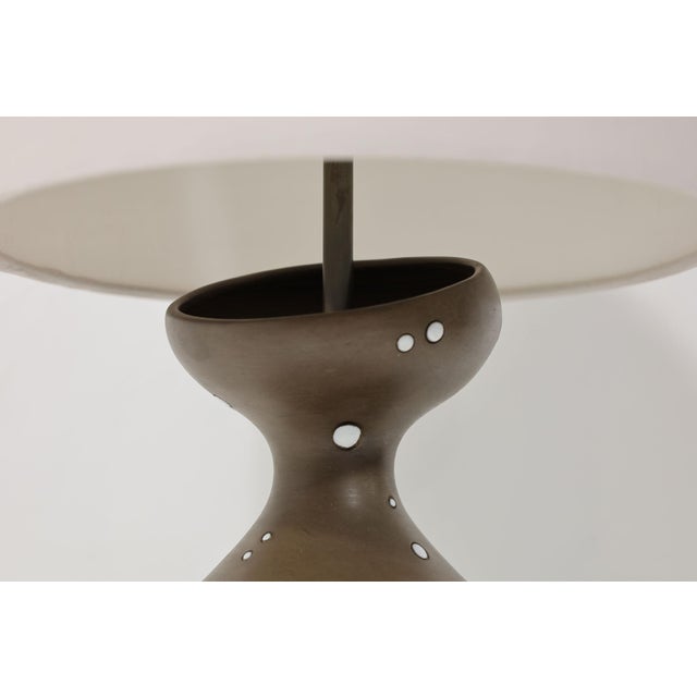 Add a touch of vintage elegance to your space with the Raymor Italian Ceramic Table Lamp, 1978. This beautiful uniquely...