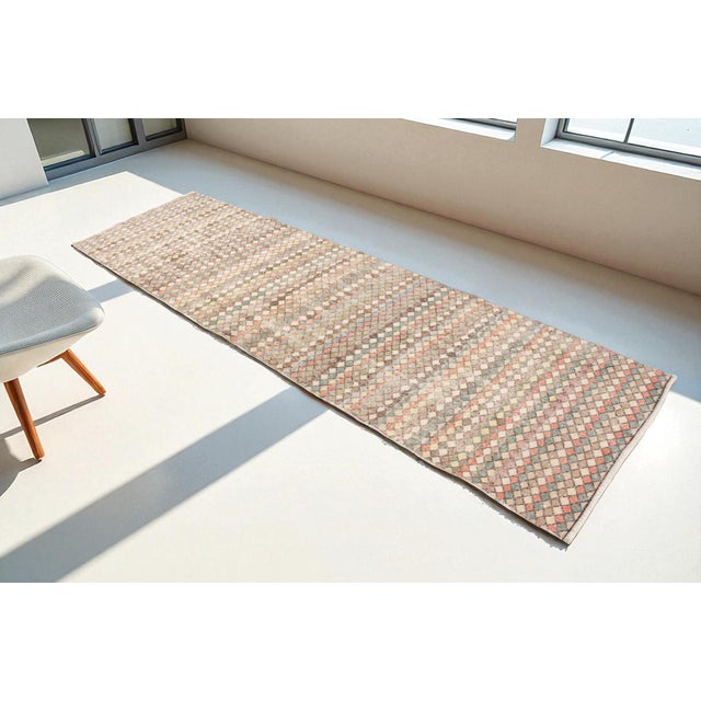 This is a vintage Turkish Oushak rug from the 1960s. The piece was hand-knotted.