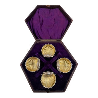 Early 20th Century Boxed Set of Four Shell Form Silver Plated Gilt Salt Dishes With Dolphin Supports For Sale