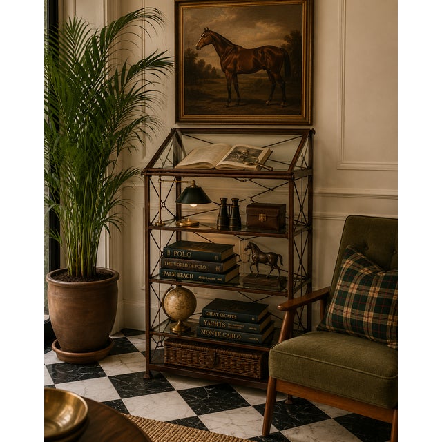 Elegant vintage iron and glass étagère featuring a refined open-frame silhouette with delicate crossed metal detailing and...
