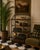 Elegant vintage iron and glass étagère featuring a refined open-frame silhouette with delicate crossed metal detailing and...