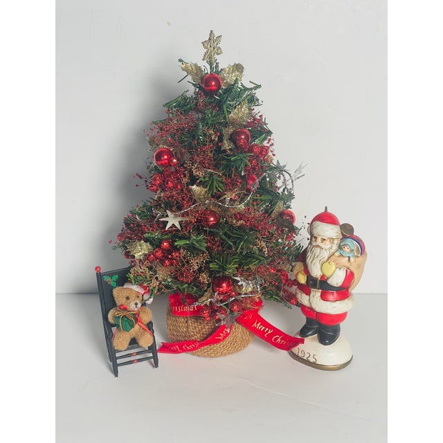Vintage 9” small Christmas tree with porcelain figure of Santa Claus and small teddy bear . Cute Holiday decor installation.