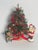 Vintage 9” small Christmas tree with porcelain figure of Santa Claus and small teddy bear . Cute Holiday decor installation.