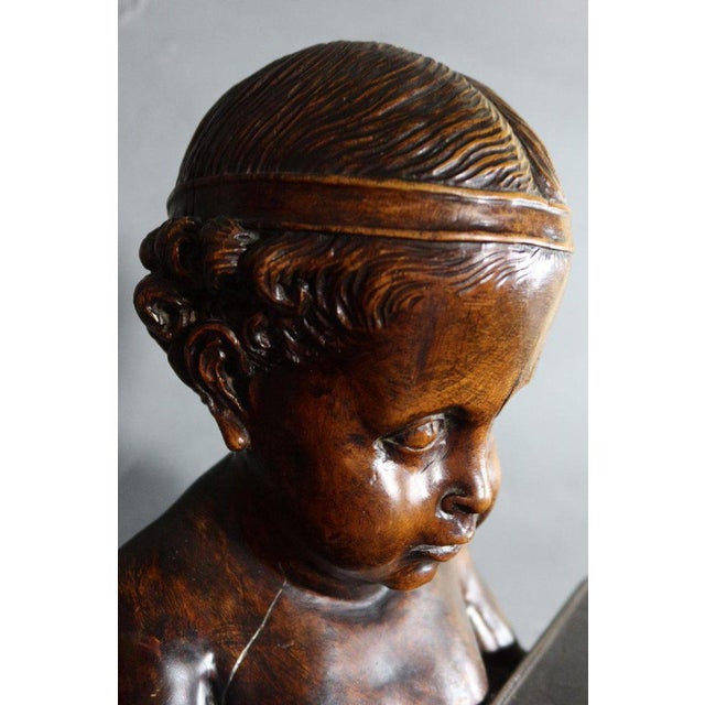 "Sculpture" of a child servant "XIX" natural wooden sculpture tinted mahogany appearing a child servant carrying a tray....
