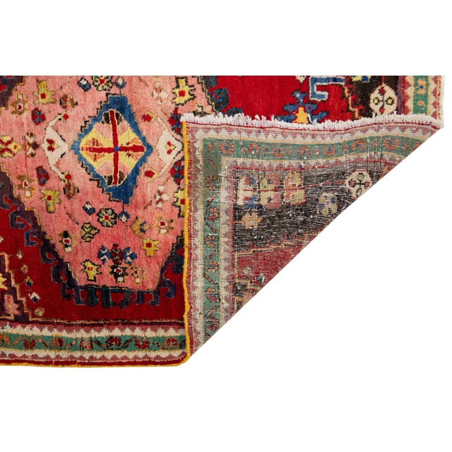 This Persian Hamadan wool rug with red field and multicolor accents allover the medallion design. Ths rug measures 3'4" x 5'.