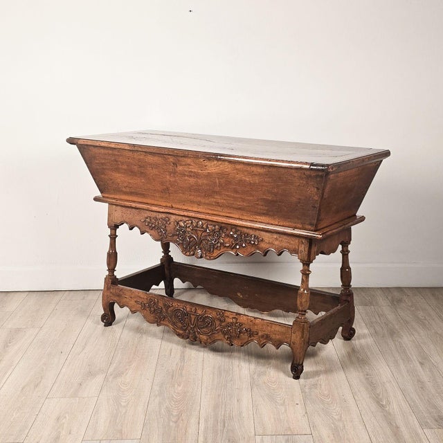 A French provincial walnut dough bin, circa 1800. Old worm damage to inside of top, to inside of bin, and to stretchers.
