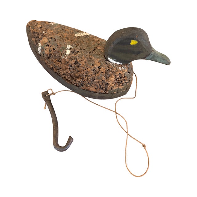 An authentic vintage working duck decoy featuring a hand-carved wooden head, genuine cork body construction, and its...