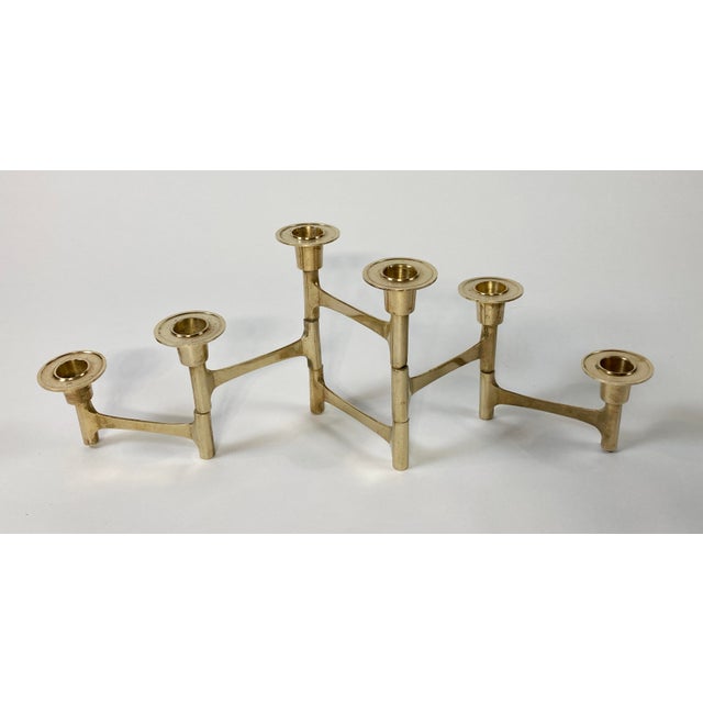 Vintage Danish style MCM brass candelabra featuring an articulating base that can fold in or out as desired. Six candle...