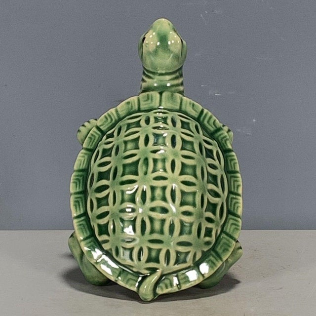 Add a touch of serene, organic charm to your space with this charming glazed ceramic turtle figurine. Featuring a rich...