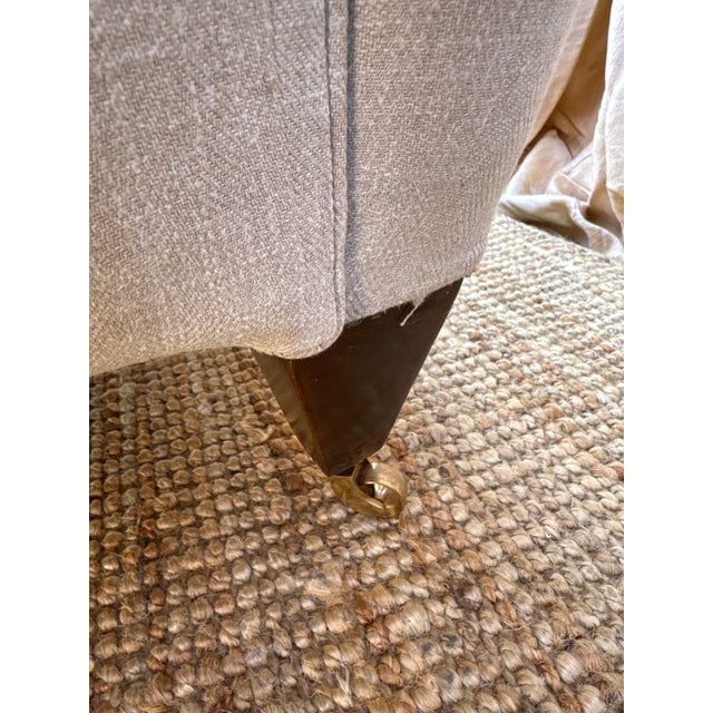 An exceptionally elegant, comfortable English armchair in new Warwick performance natural linen. A scrolled back sits atop...