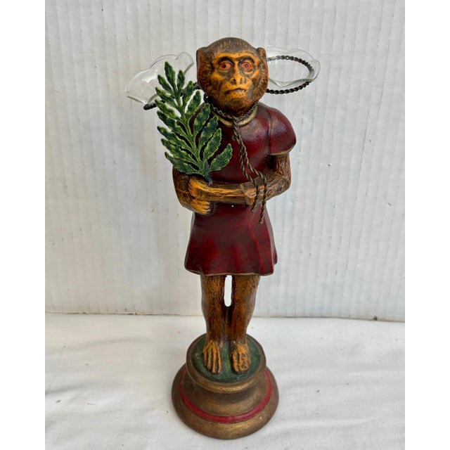 The charming figure is fitted with 2 glass flower receptacles