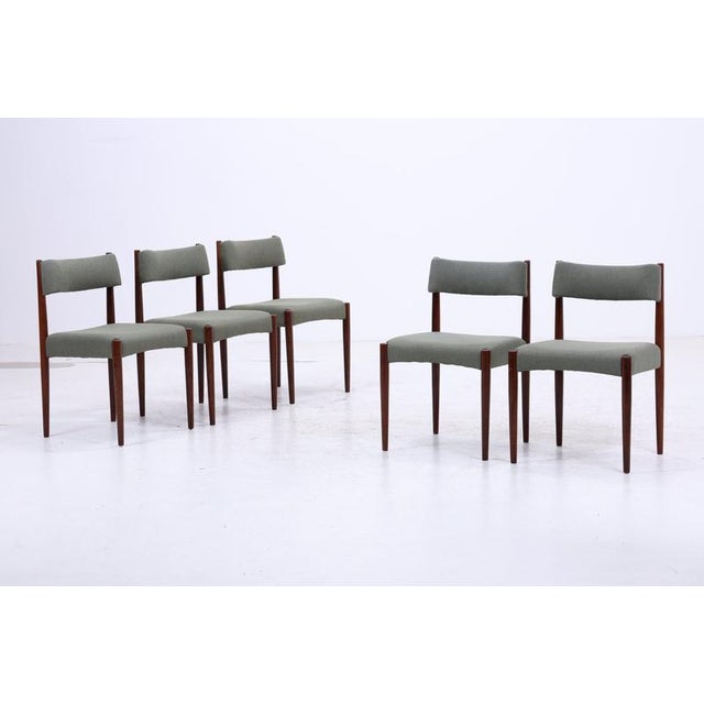 A beautiful set of five Danish dining chairs by Knud Faerch for Bovenkamp. The clean lines, slender proportions, and...