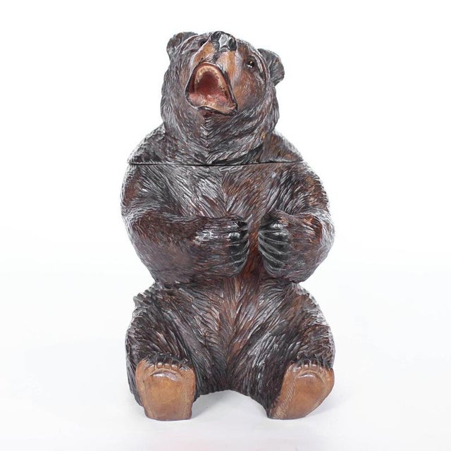 A Black Forest seated carved bear as a tobacco jar. Finely carved detail. Original glass eyes. Origin: Swiss Date: circa...