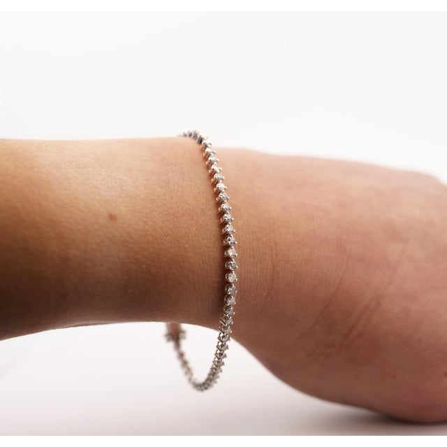 Natural Diamond Unisex Tennis Bracelet in 18K White Gold. A modern piece, this diamond bracelet features 61 round-cut...