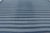 This monumental 14x15 oversized Dhurrie rug features horizontal stripes in deep indigo and soft blue, representing an...