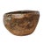 A substantial hand-hewn wooden bowl carved from a single burl section, retaining its irregular form and textured interior....