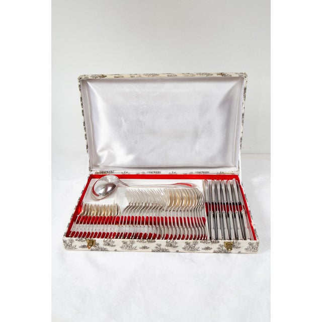 French flatware set for 12 by the prestigious firm François Frionnet, Louis XV style with a delicate shell or coquille...