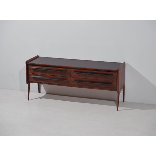 Italian mid-century dresser designed and produced in the 1950s, characterized by a long horizontal structure, four drawers...