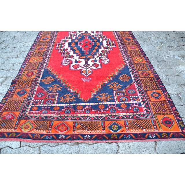 This is a vintage Turkish Oushak rug from the 1960s. The piece was hand-knotted.