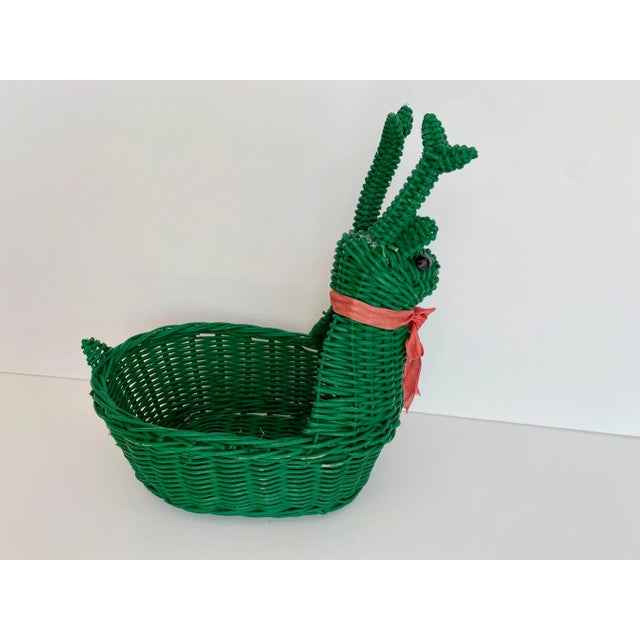 Absolutely adorable small wicket snail basket painted a bright kelly green. Has a pink ribbon, bow collar and black,...