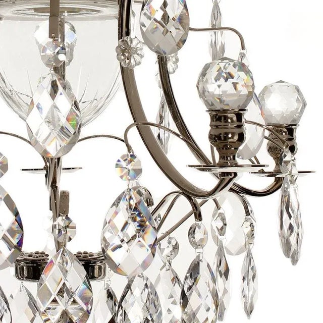 A nickel bathroom chandelier with full cut crystal orbs in the arms and cut crystal baroque almonds. The light bulb for...
