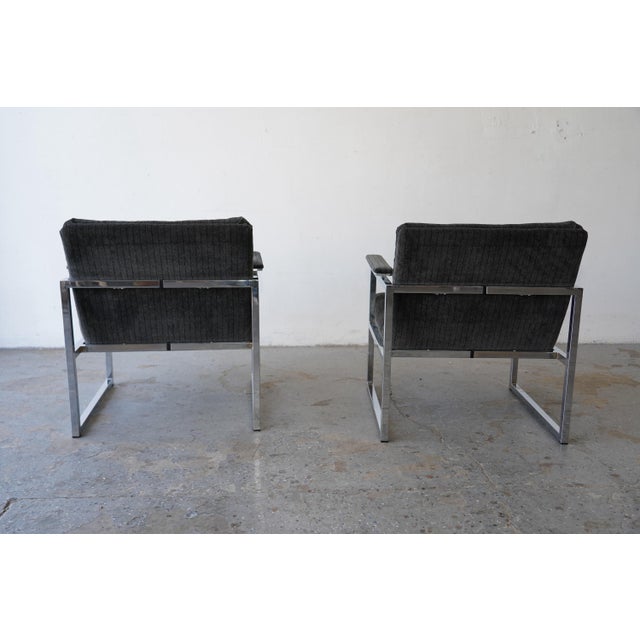 A handsome pair of vintage lounge chairs in the style of Milo Baughman, circa 1970s. Each chair is framed in polished...