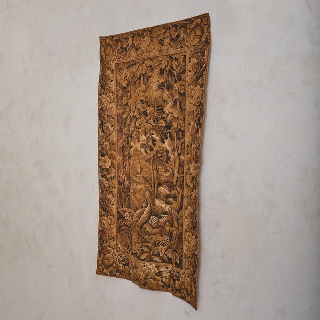 A late 19th-century French tapestry, hand-woven in wool and later backed in cotton, composed in a warm palette of sepia,...