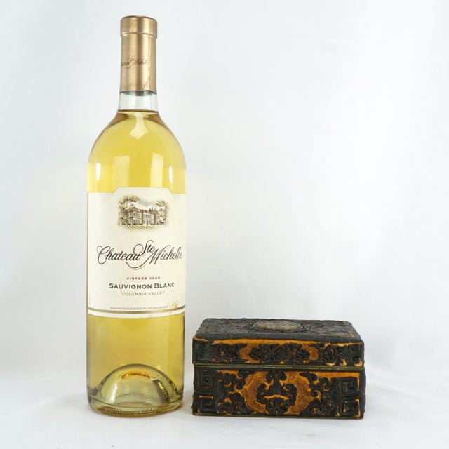 A black lacquer and gold enamel box topped with a pierced medallion of the He He Twins in the center of the lid. The box...