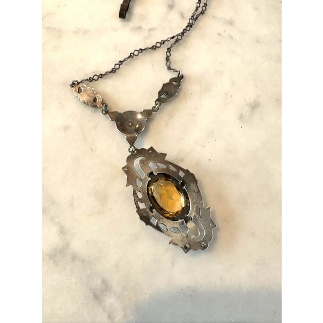 Gorgeous, antique art nouveau sterling silver, marcasite, and citrine pendant necklace. Features floral motif, a stunning...