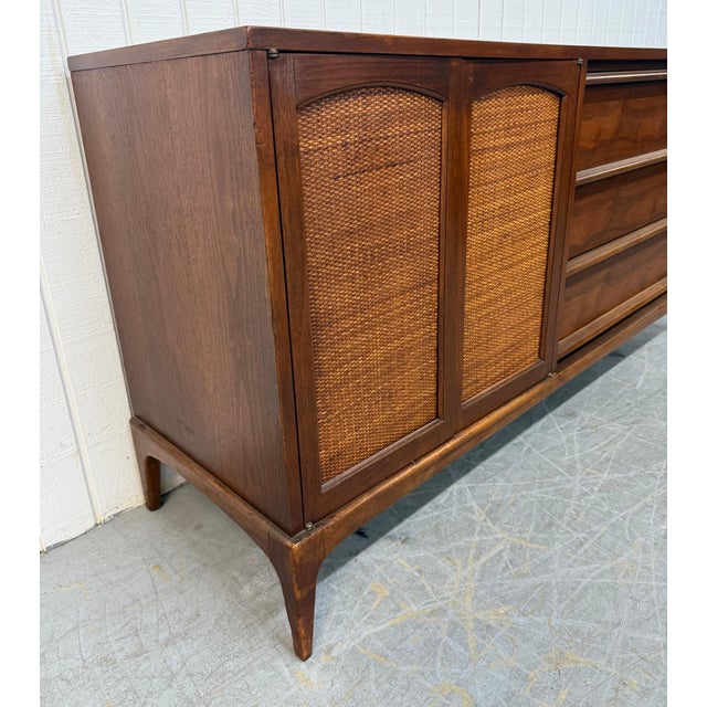 This listing is for a Mid-Century Modern Lane Rhythm Walnut Sideboard. Featuring a straight line design, two cane doors...