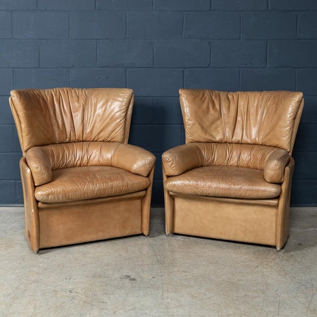 Pair of brown leather armchairs, model Ventaglio (fan), by Lev & Lev, Italy, circa 1970. These sculptural armchairs take...