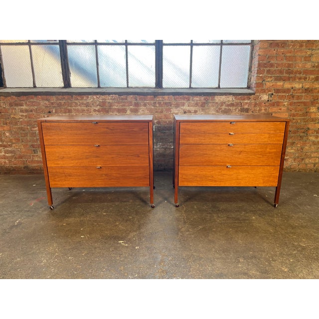 Beautiful matching pair of Florence Knoll four-drawer walnut dressers featuring stunning wood grain, minimal chrome pulls,...