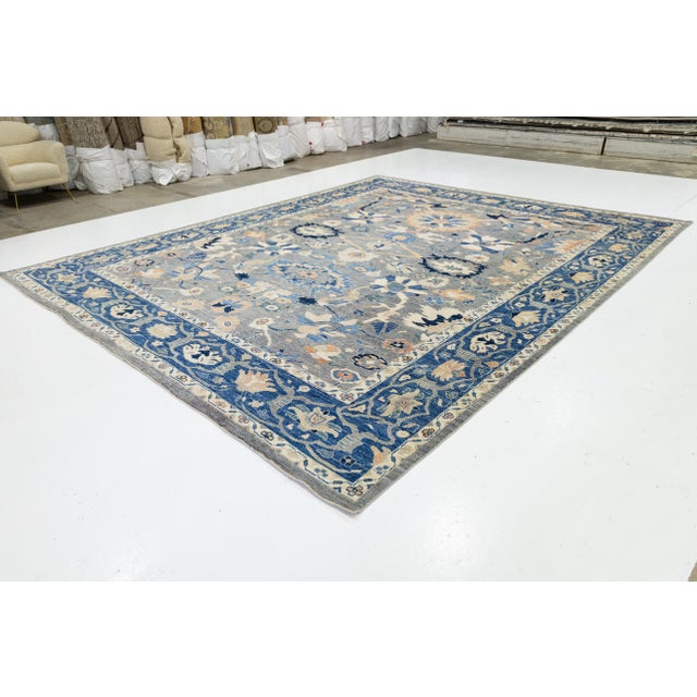 Elevate your living space with this exquisite Modern Oushak Style Wool Rug. Masterfully hand-knotted, this rug features...