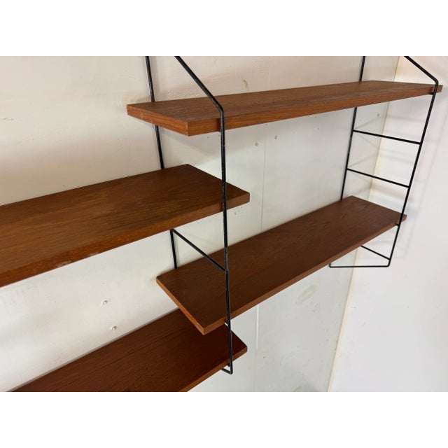 Vintage Mid Century Modernist String teak and steel wall system. You can put the shelves on différent positions. This...