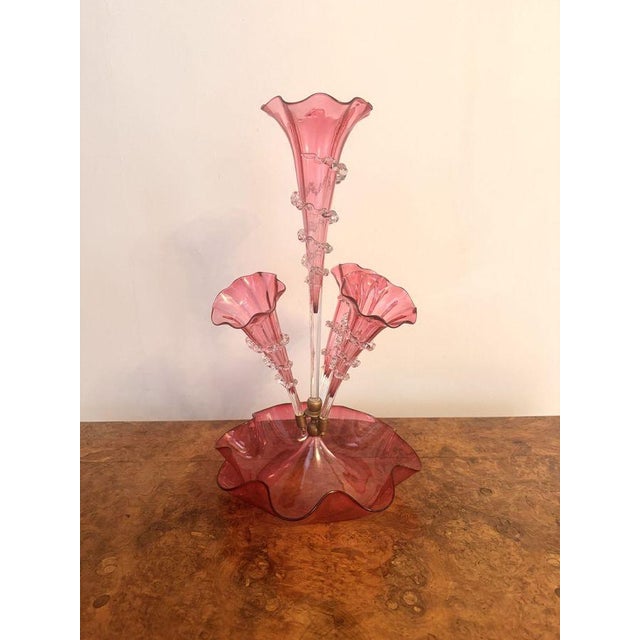 Antique Victorian quality cranberry glass epergne, having a quality original cranberry glass epergne with one tall trumpet...