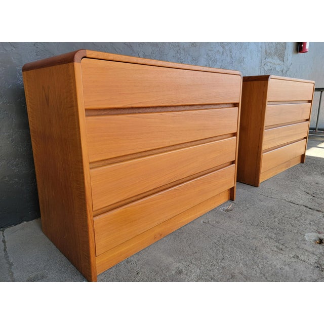 A matched pair of teak Danish Modern Dressers. Made in Denmark, circa. 1960's. Exceptional original finish and condition....