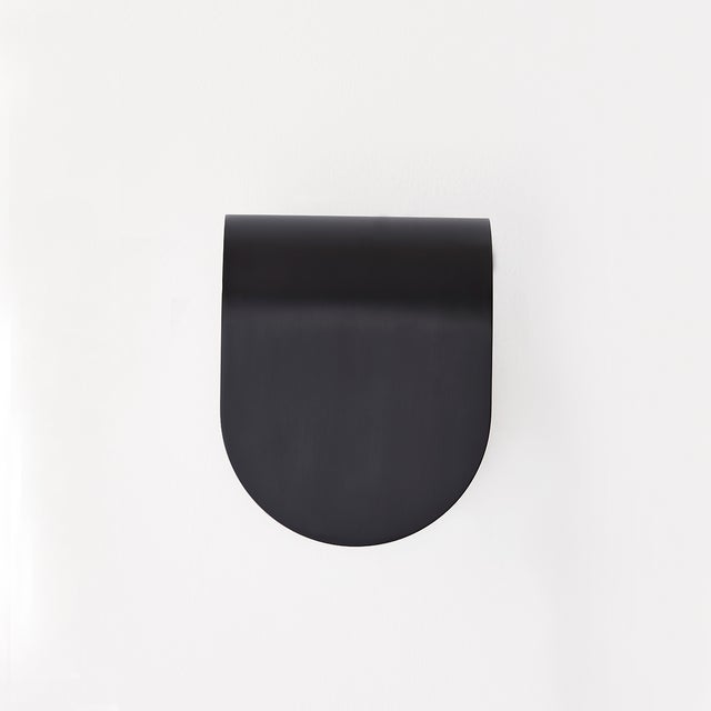 The lines of a curved piece of Aged Brass or Black Brass flow effortlessly into the smooth lines of an alabaster shade...