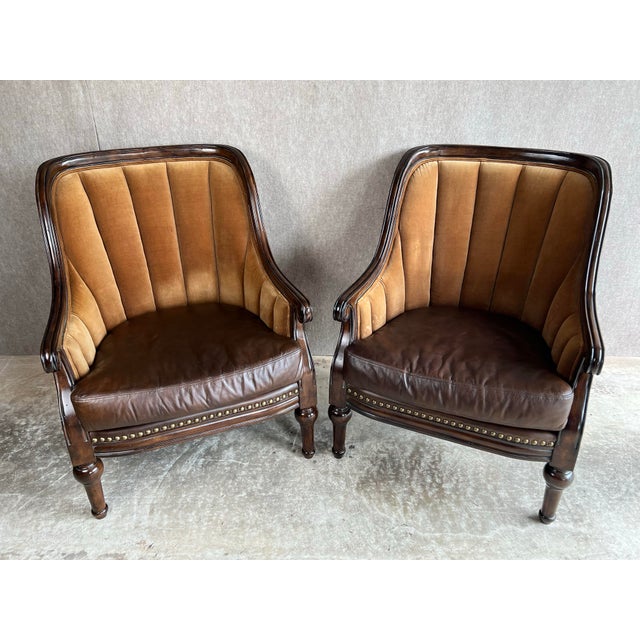 Fabulous pair of leather and velvet channel back library club chairs. These large, quality chairs feature distressed wood...