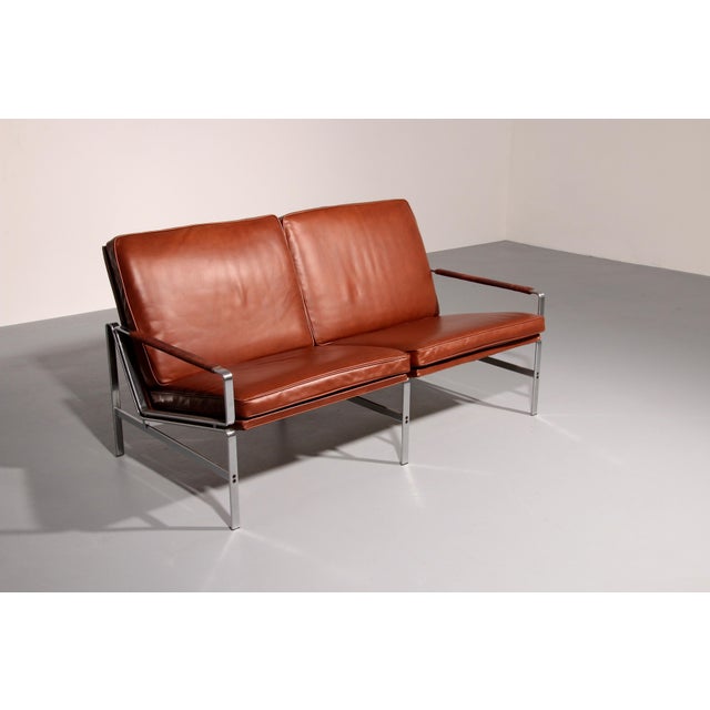 Design two-seater sofa model fk 6720 from fabricius & kastholm, brown leather discover the perfect combination of style...