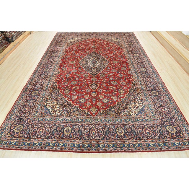 An authentic vintage traditional Kashan rug hand-knotted with fine wool and natural dyes. This oriental rug features a...