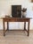 This antique English oak table or desk dates to the late 18th or early 19th century and reflects the quiet practicality of...