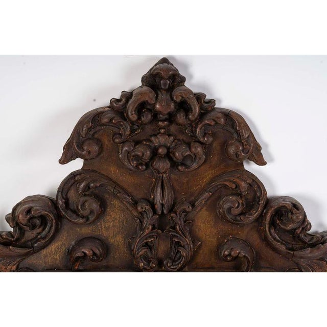 Baroque regency style wall mirror in carved and patinated wood, 19th century. A large baroque regency style wall mirror in...