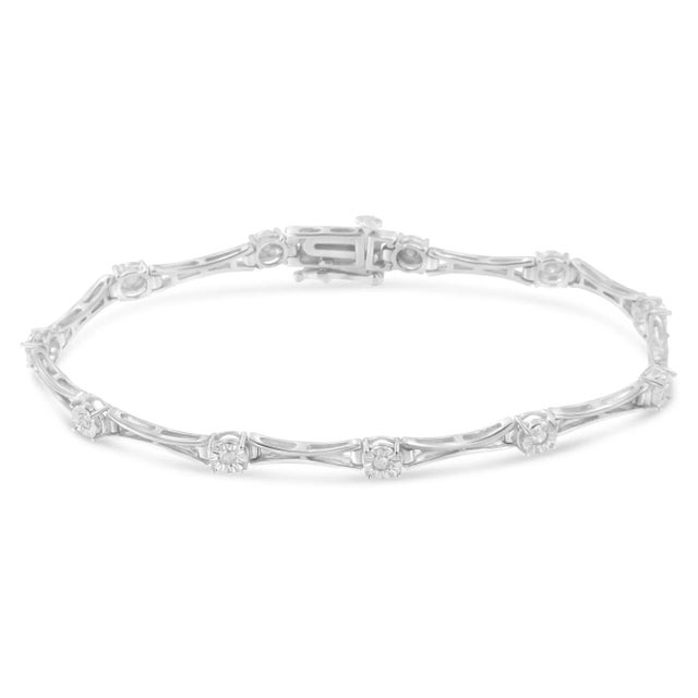 Elegant and timeless, this gorgeous .925 sterling silver tennis bracelet features 0.25 carat total weight of round, promo-...