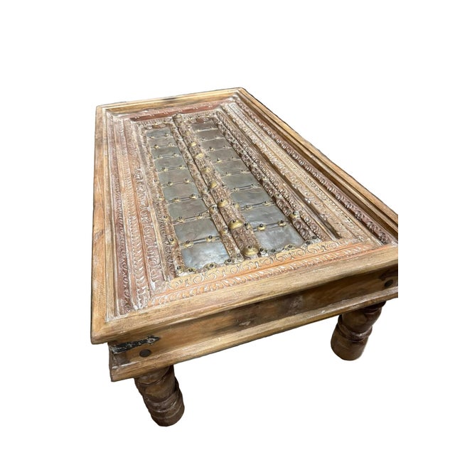 Crafted from an authentic antique door, this stunning coffee table celebrates the artistry of traditional Indian...